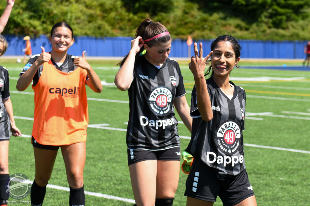 Niki Virk holds up 3 fingers after a win