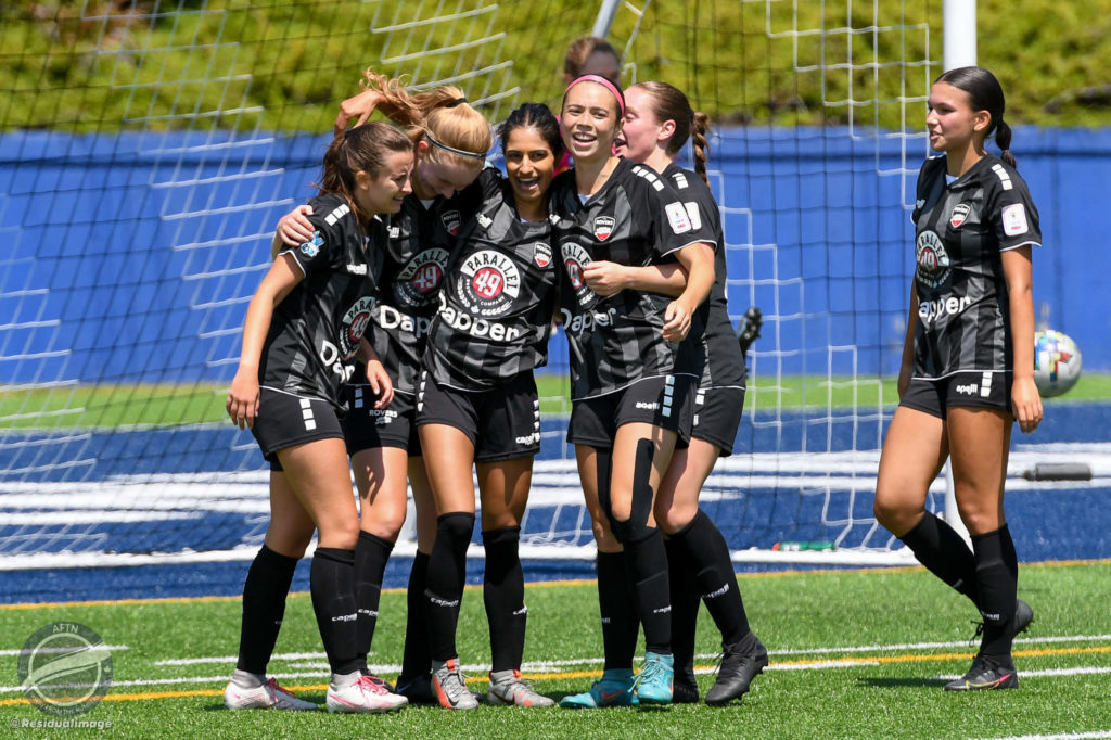 Niki Virk celebrates a goal with teammates