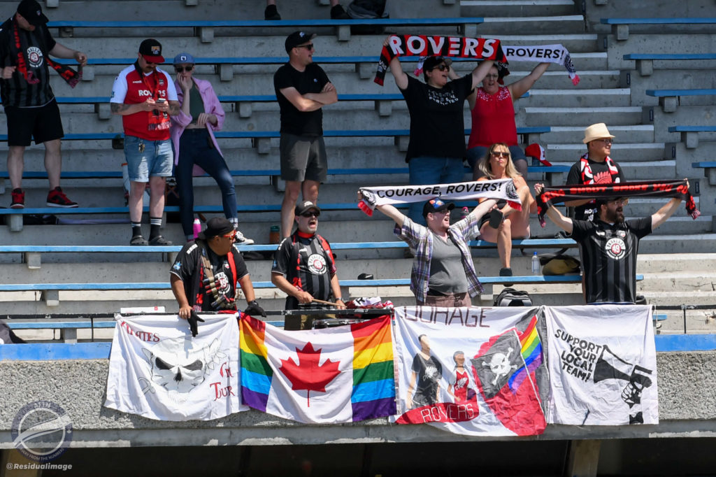 Swanguardians singing and holding up scarves