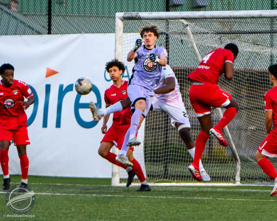 GK Cal Weir leaps and punches a dangerous cross away